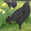 Metal artwork Pecker in garden flowers