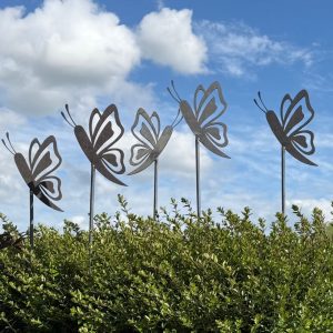 A stunning display of five metal butterfly garden sculptures grouped together